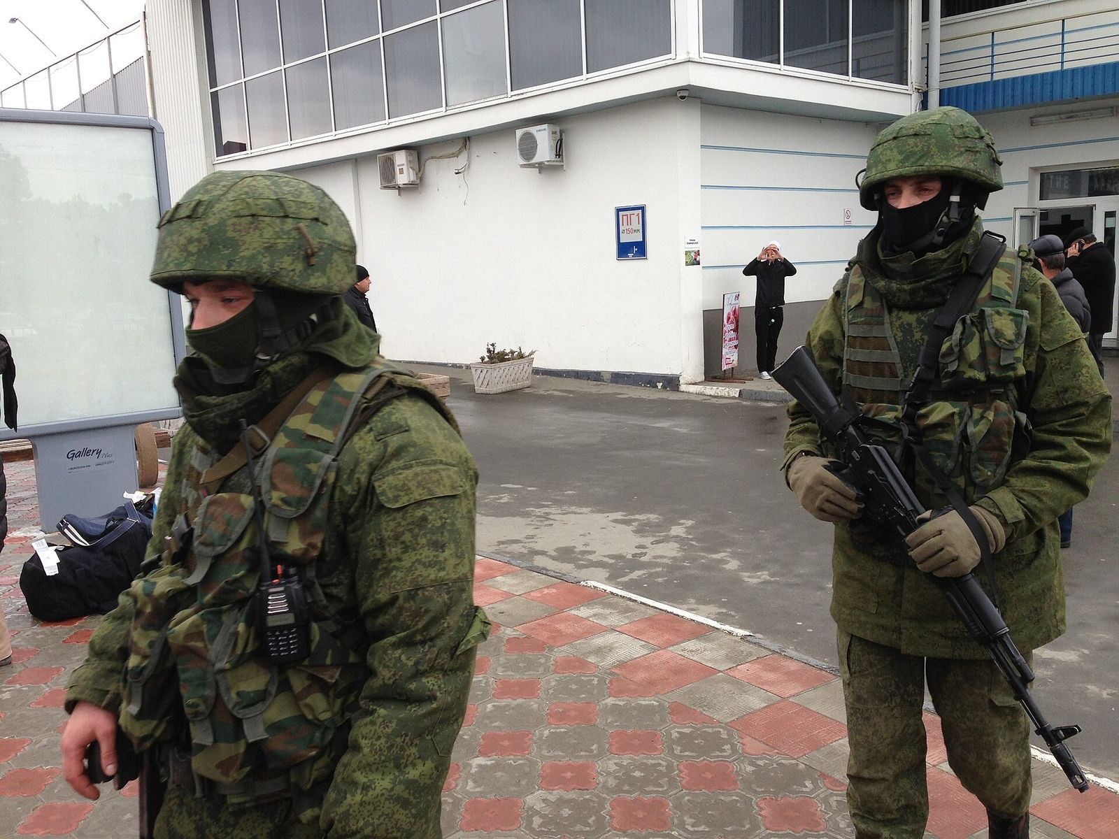 Unmarked armed men — 'little green men' — on patrol at Simferopol Airport, Crimea, March 2014