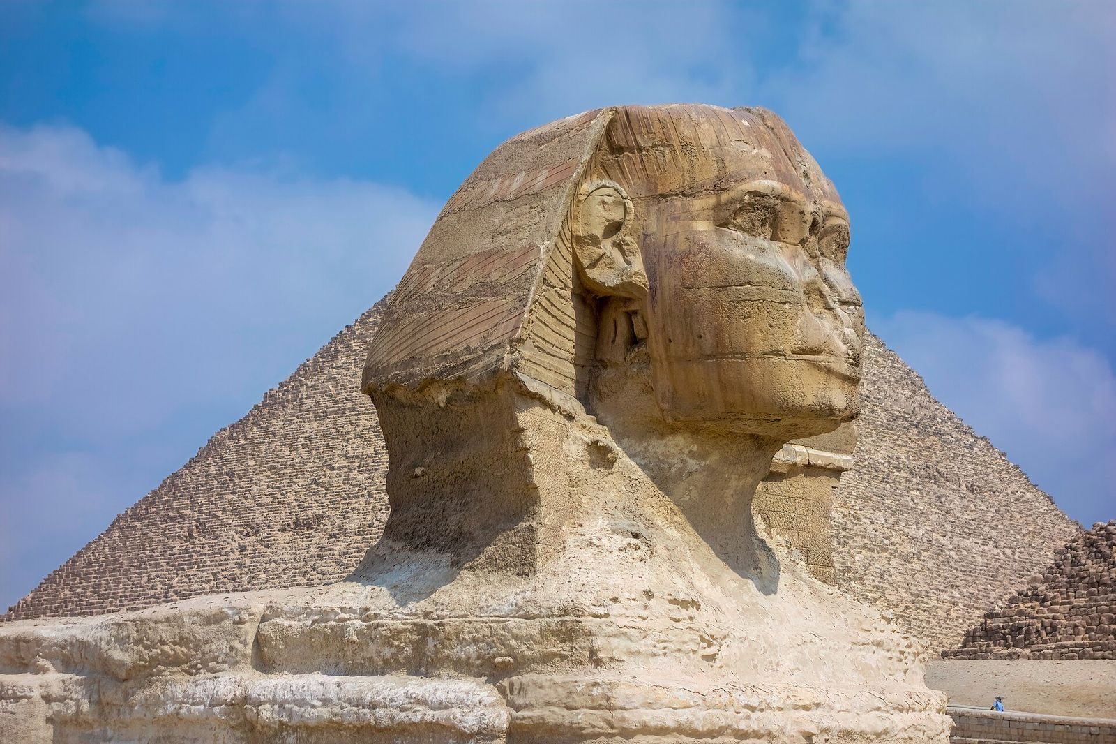 Le Grand Sphinx de Gizeh, les pyramides se dressant derrière lui sur le plateau désertique