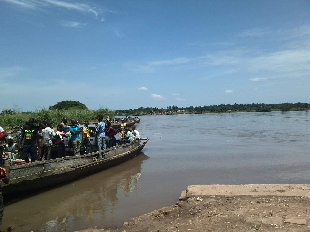 A car being ferried across the Benue River in Nigeria, the river from which 15 bodies were recovered after the attack on Binnari village in Taraba State