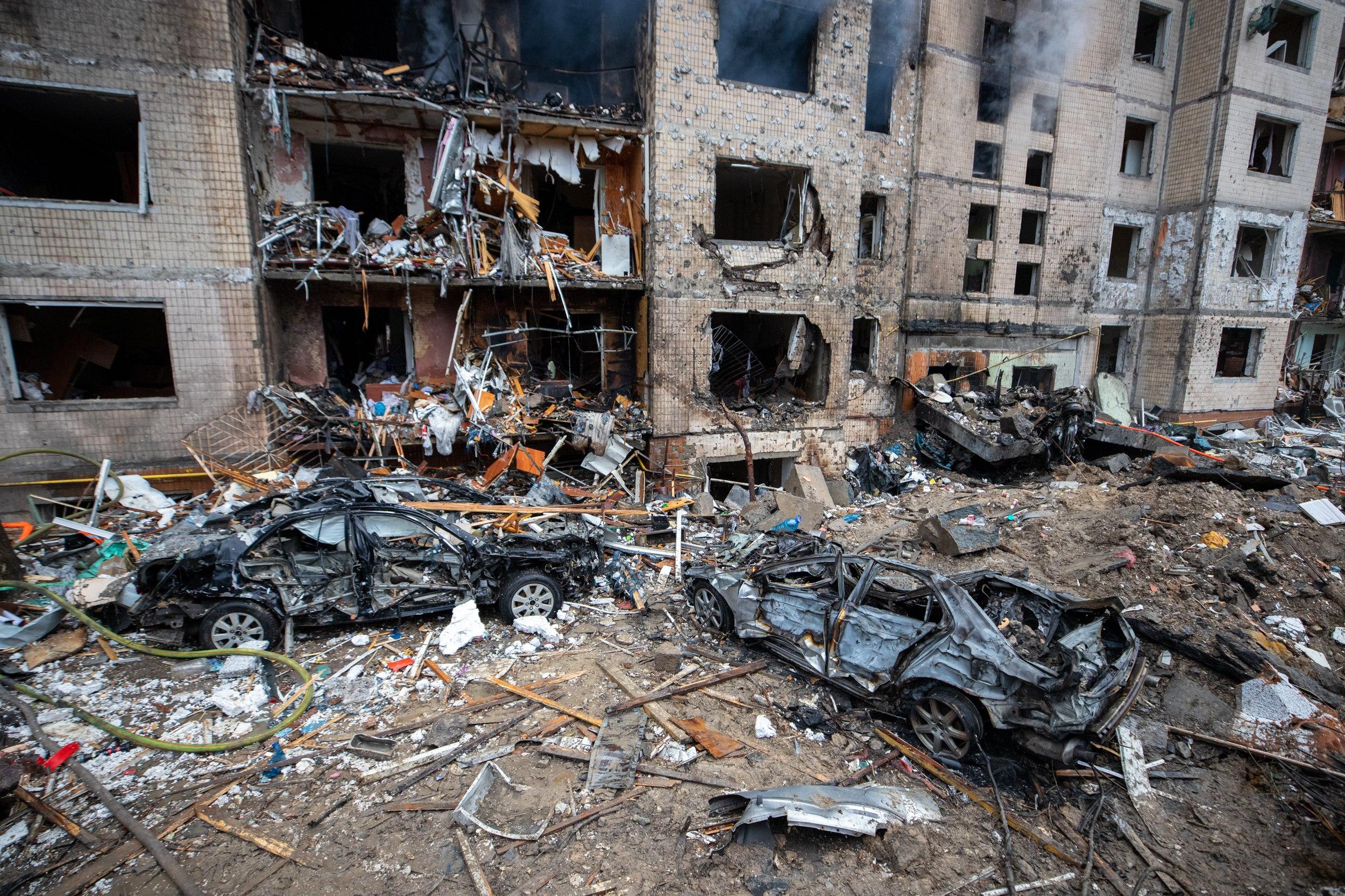 A damaged five-storey residential building in Kyiv after a Russian missile strike: firefighters and rescuers work amid shattered concrete, rubble and collapsed apartments