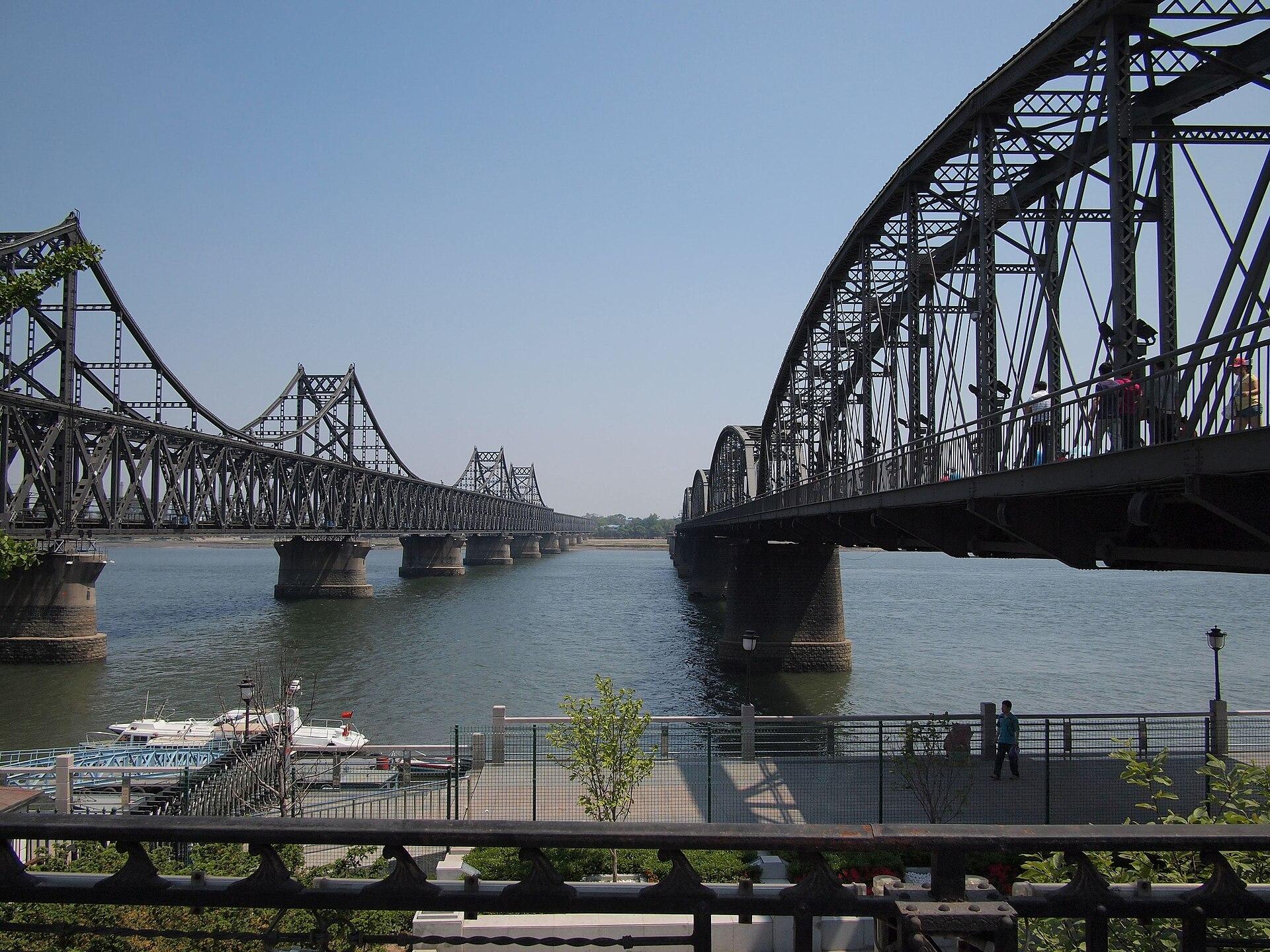 The ageing Sino-Korean Friendship Bridge (left) and the war-damaged 1911 bridge at Dandong, China — the old Yalu River crossings the new bridge will relieve